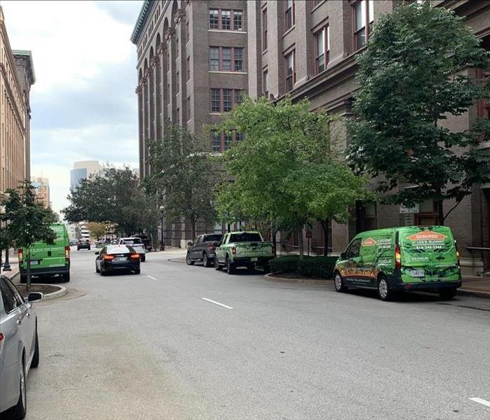 3 green SERVPRO vans in front of a commercial building