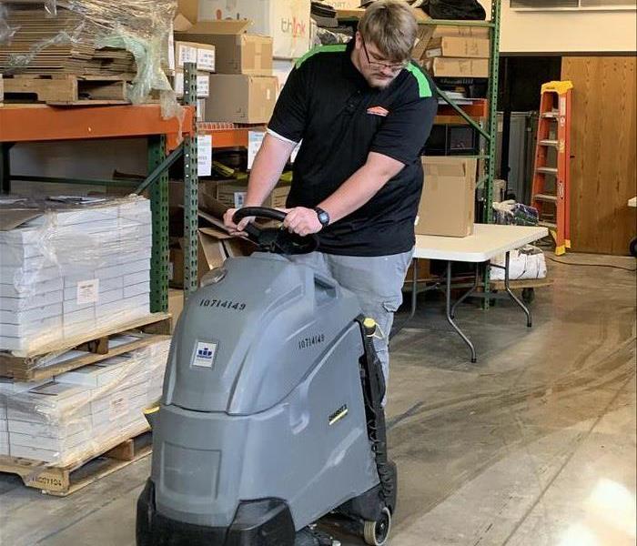 SERVPRO team member in action cleaning floors.