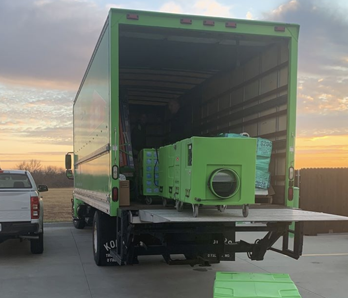 a servpro truck with a sunset in the background